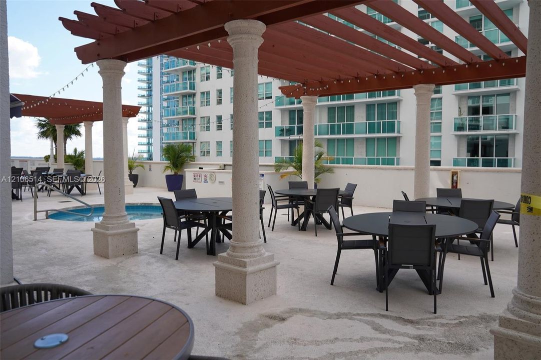 Rooftop terrace featuring stone columns, wood-finish pergolas, and an outdoor plunge pool
