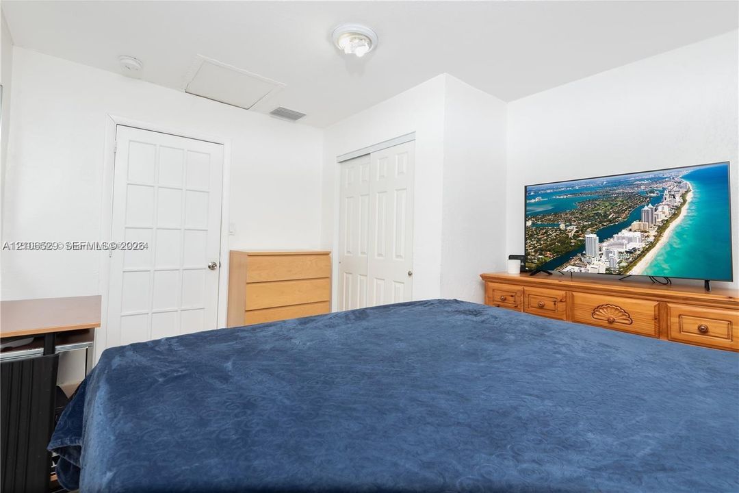 Interior space featuring a multi-pane glass panel door, a sliding two-panel closet door, and a ceiling-mounted light fixture