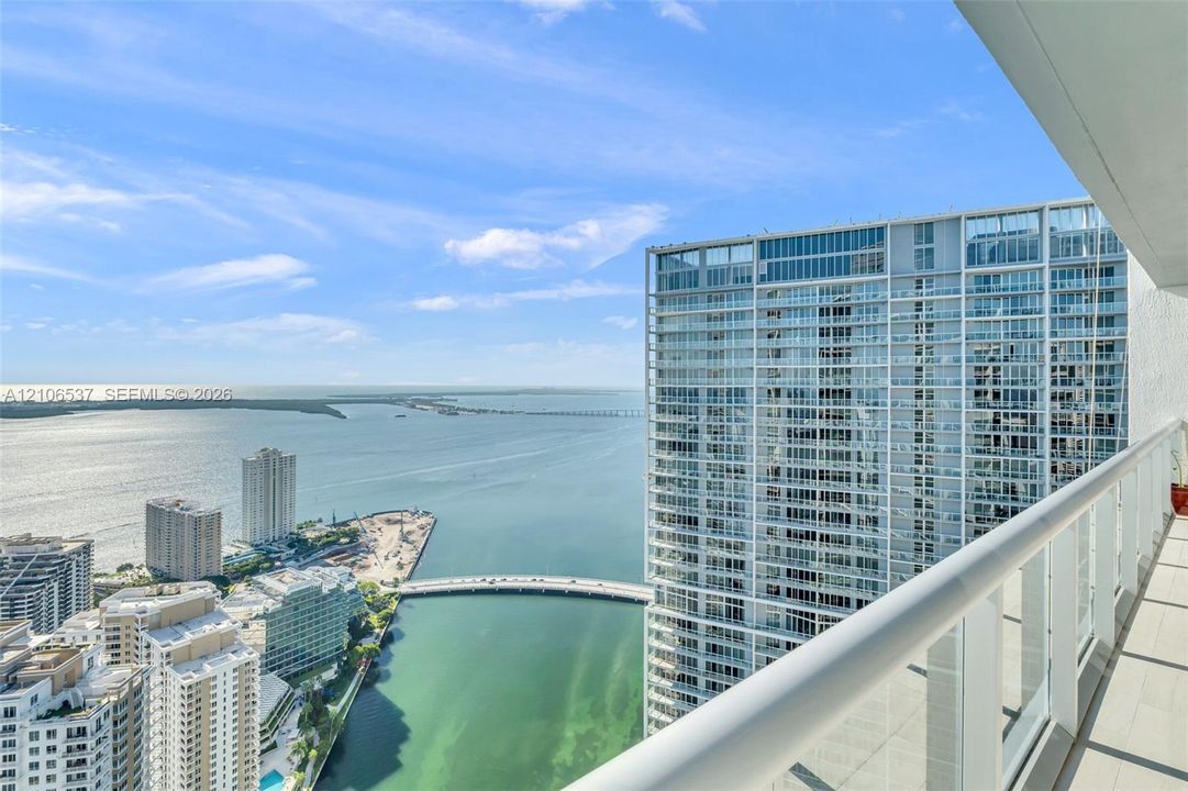 Private balcony featuring glass-panel railings and tile flooring