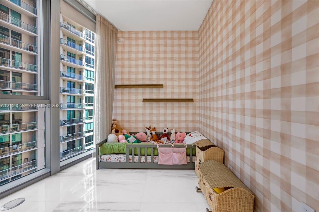 Floor-to-ceiling windows with expansive glass panels, light-toned check-patterned wall covering, dual built-in wall shelves, and polished stone-finish tile flooring