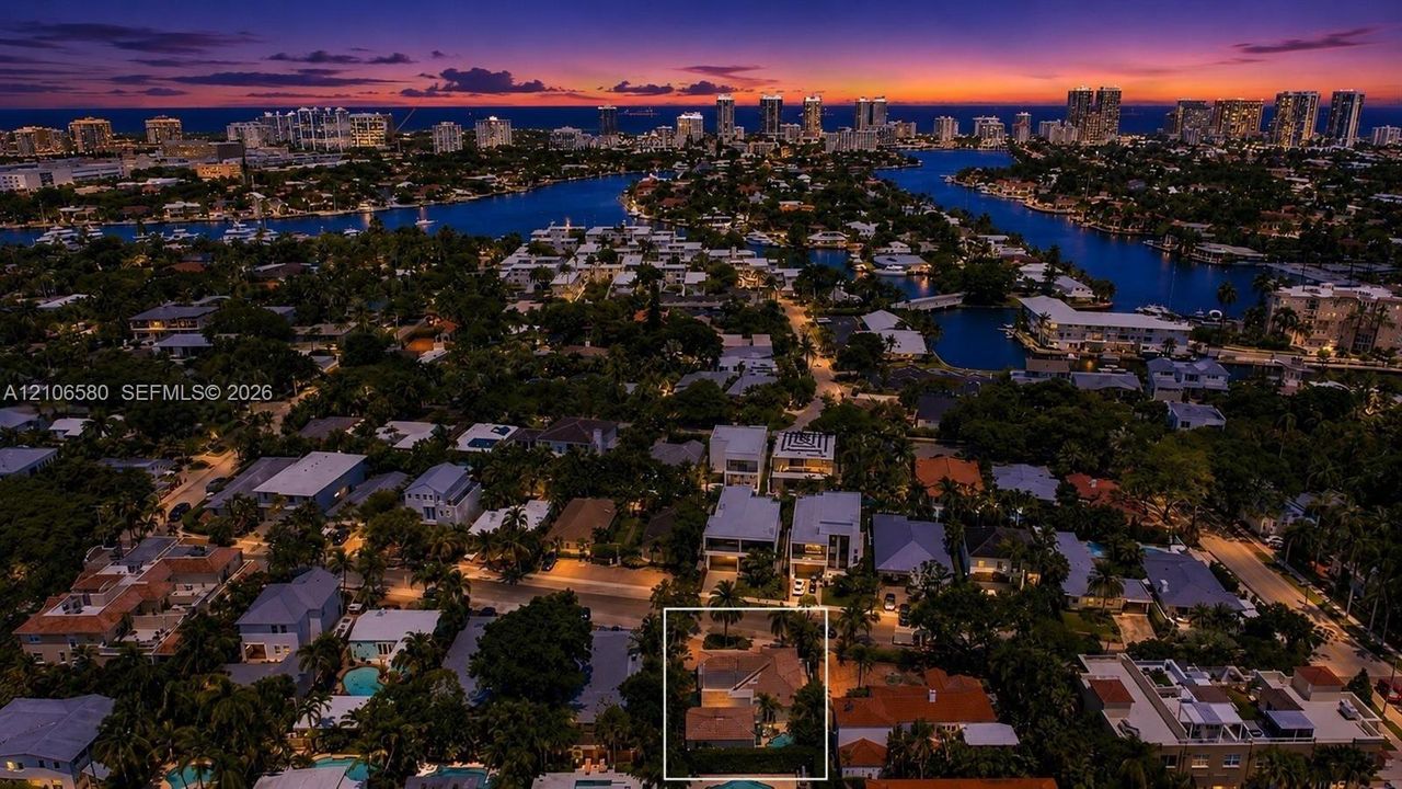 Aerial perspective of residential property featuring a pitched roof, mature landscaping, and a secluded rear yard