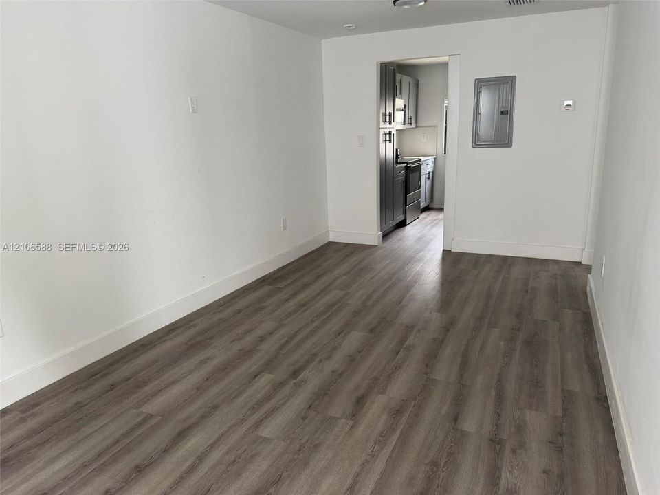 Wood-finish flooring with neutral wall paint and recessed ceiling lighting