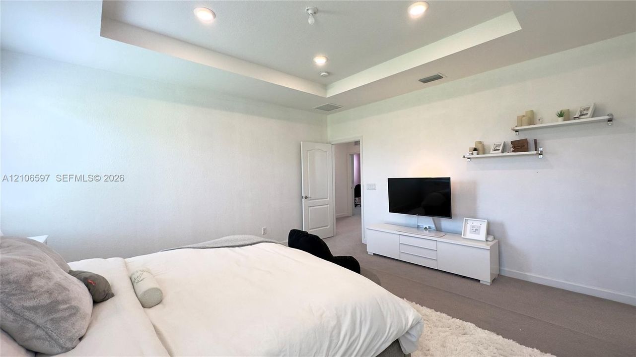 Tray ceiling, recessed lighting, and wall-mounted shelving