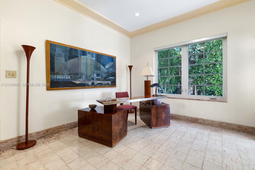 Room featuring large-format stone tile flooring, multi-pane window with exterior greenery, and recessed ceiling lighting
