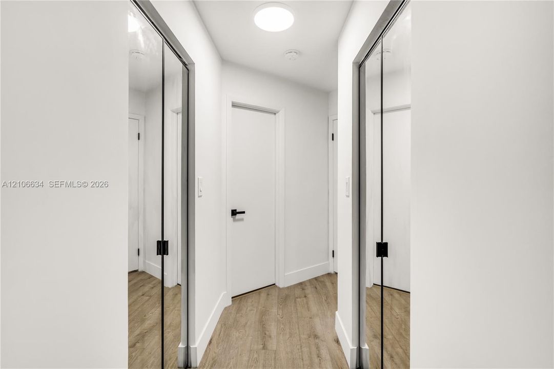 Two walk-in closets at entry way of Primary Bedroom