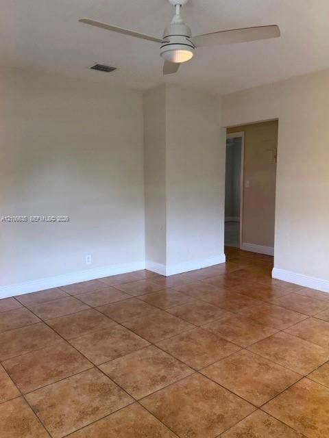 Ceramic tile flooring throughout with a white ceiling fan and integrated light fixture