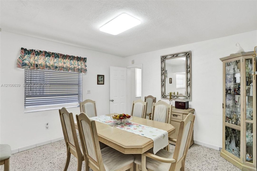 Interior space featuring terrazzo flooring, horizontal window blinds, and a flush-mount rectangular light fixture