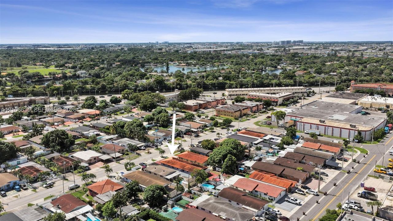 Aerial perspective featuring a single-story structure with a tile roof and dedicated surface parking