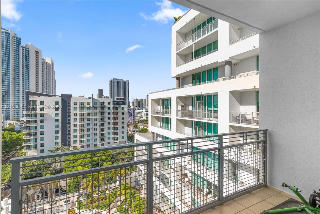 Private balcony featuring tiled flooring and a metal grid railing