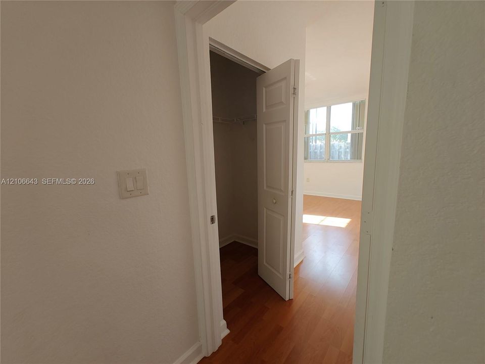 Room featuring wood-finish flooring, neutral walls, and multiple grid-pattern windows