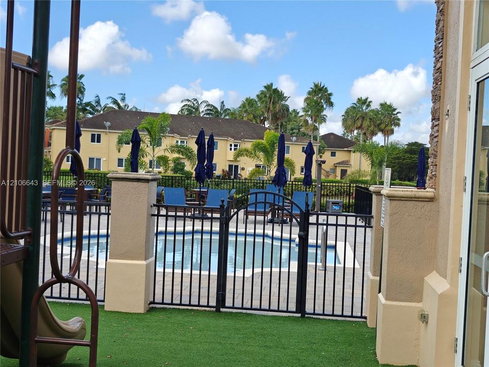 Large format tile flooring featuring neutral tones and multiple glass doors providing exterior exposure