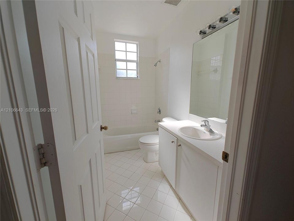 Laundry closet featuring bi-fold doors, white appliance hookups, and built-in wire shelving