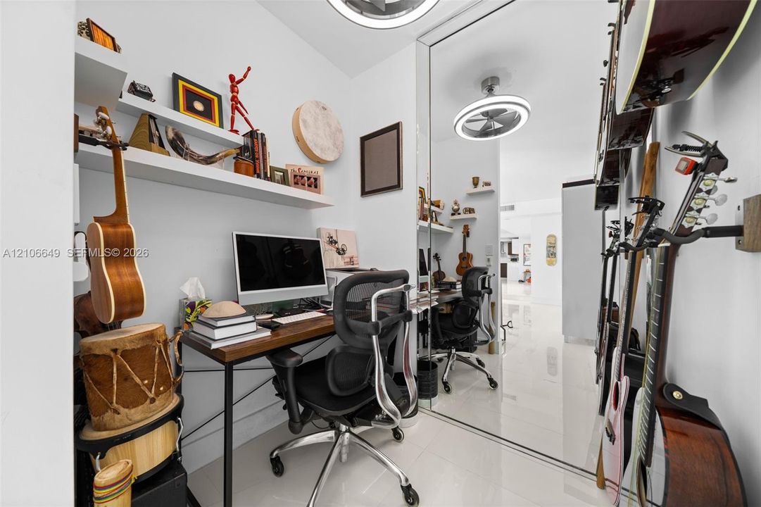 Polished tile flooring, built-in wall-mounted shelving, floor-to-ceiling mirror paneling, and circular LED overhead lighting