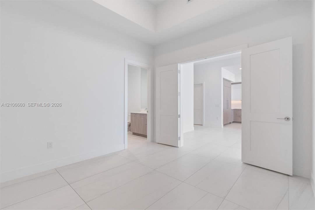 Tray ceiling, large-format tile flooring, and Shaker-style interior doors