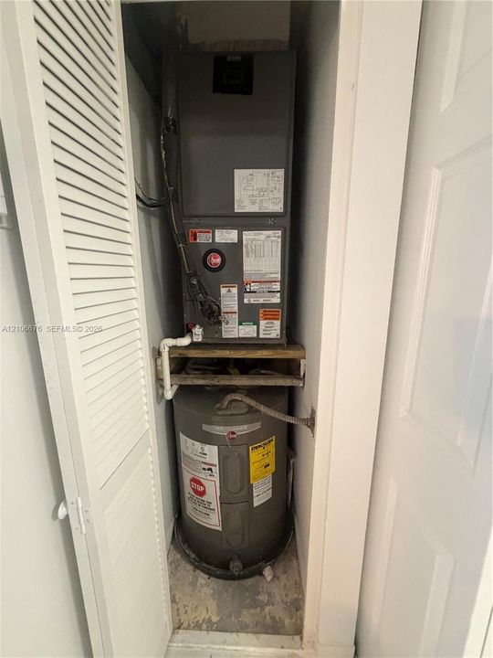 Mechanical closet housing a Rheem furnace unit and a vertical water heater