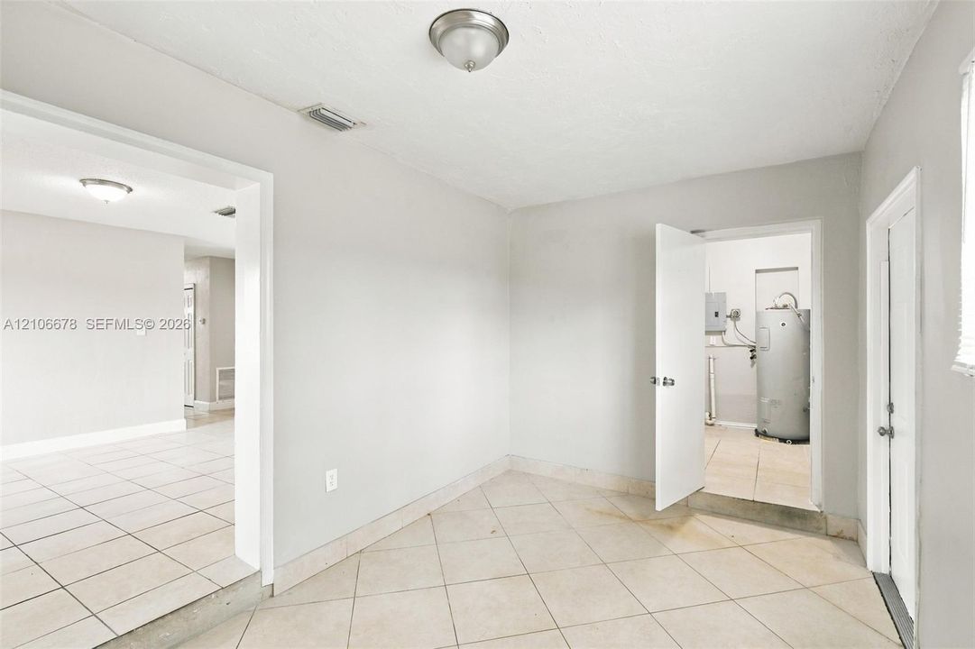Interior space featuring neutral wall paint, tile flooring laid on a diagonal pattern, and flush-mount ceiling light fixtures