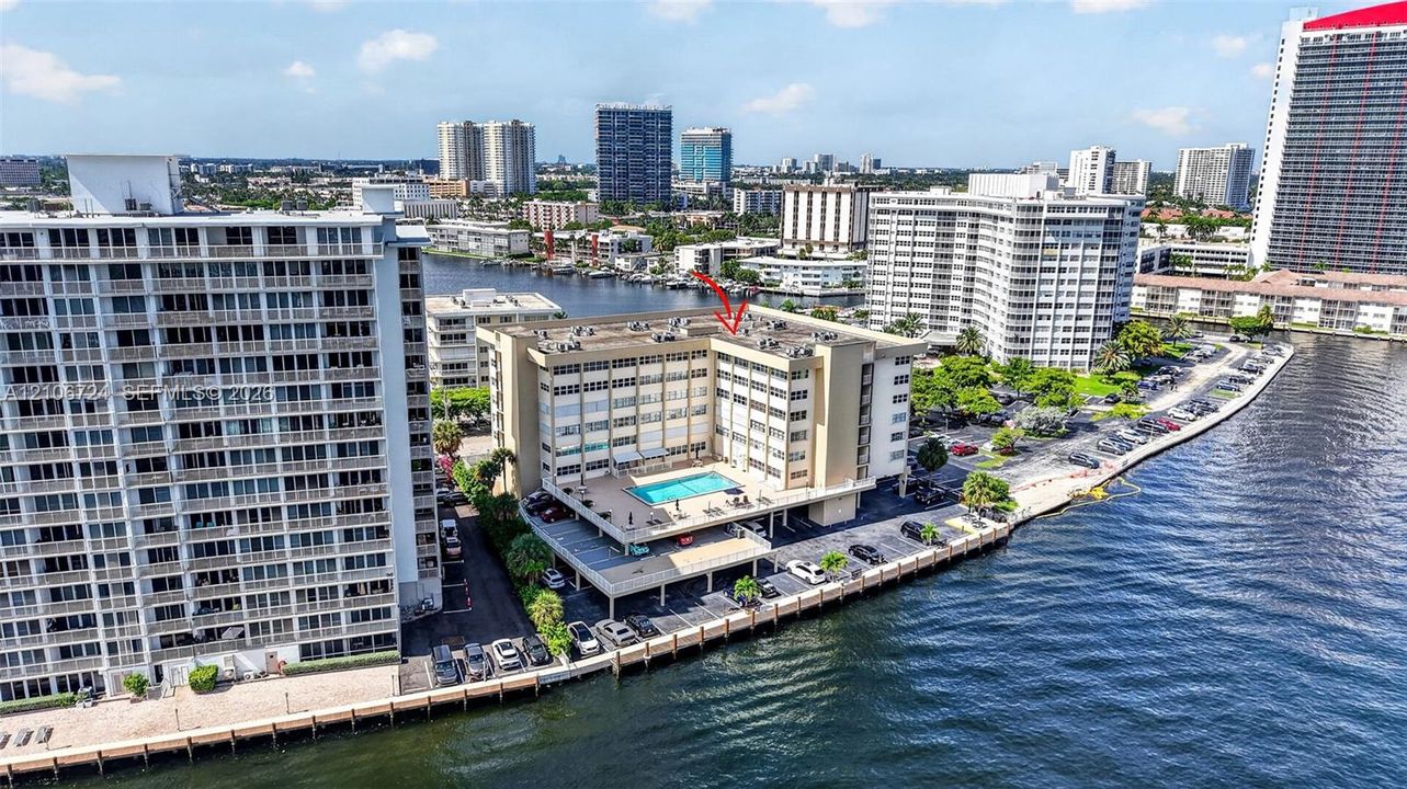 Mid-rise waterfront building featuring a rooftop swimming pool and direct bulkhead access