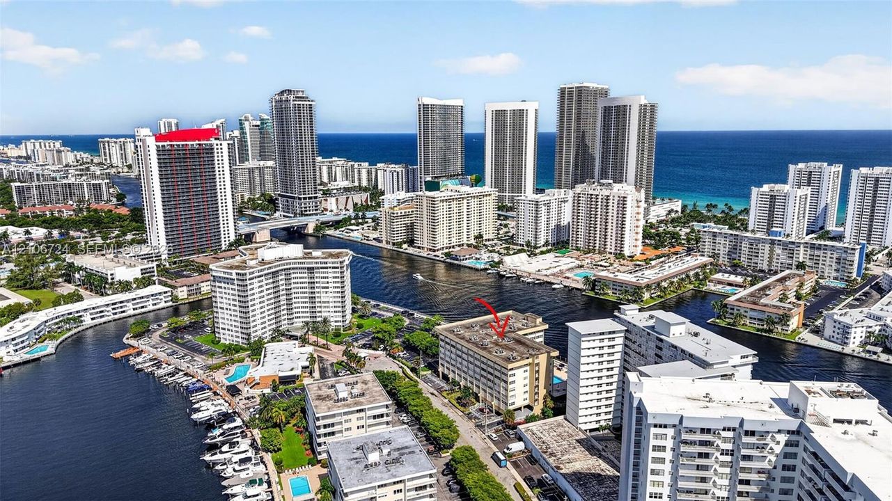 Multi-story building positioned along a waterway with proximity to coastal shorelines and high-density urban infrastructure