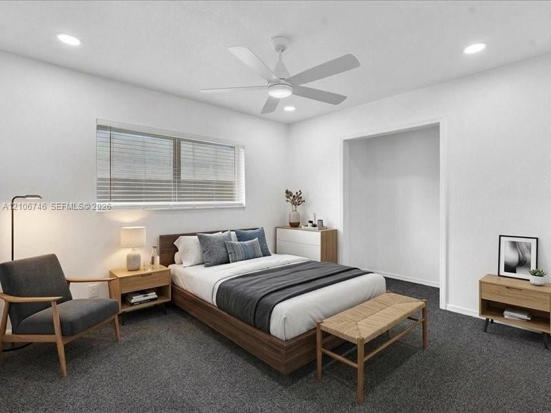 Neutral-toned interior featuring recessed lighting, a modern white ceiling fan, and wall-to-wall carpeting