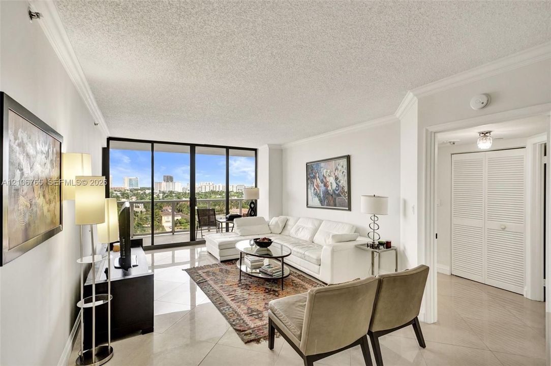 Floor-to-ceiling glass doors opening to a balcony.