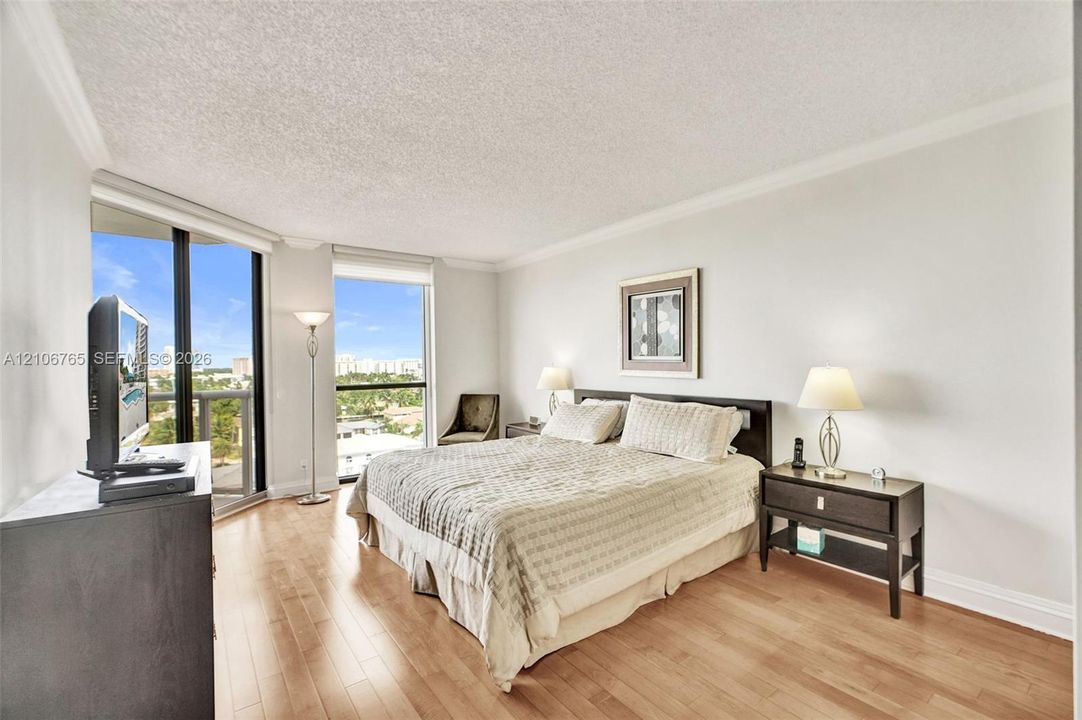 Main bedroom. wood floors, floor-to-ceiling windows.