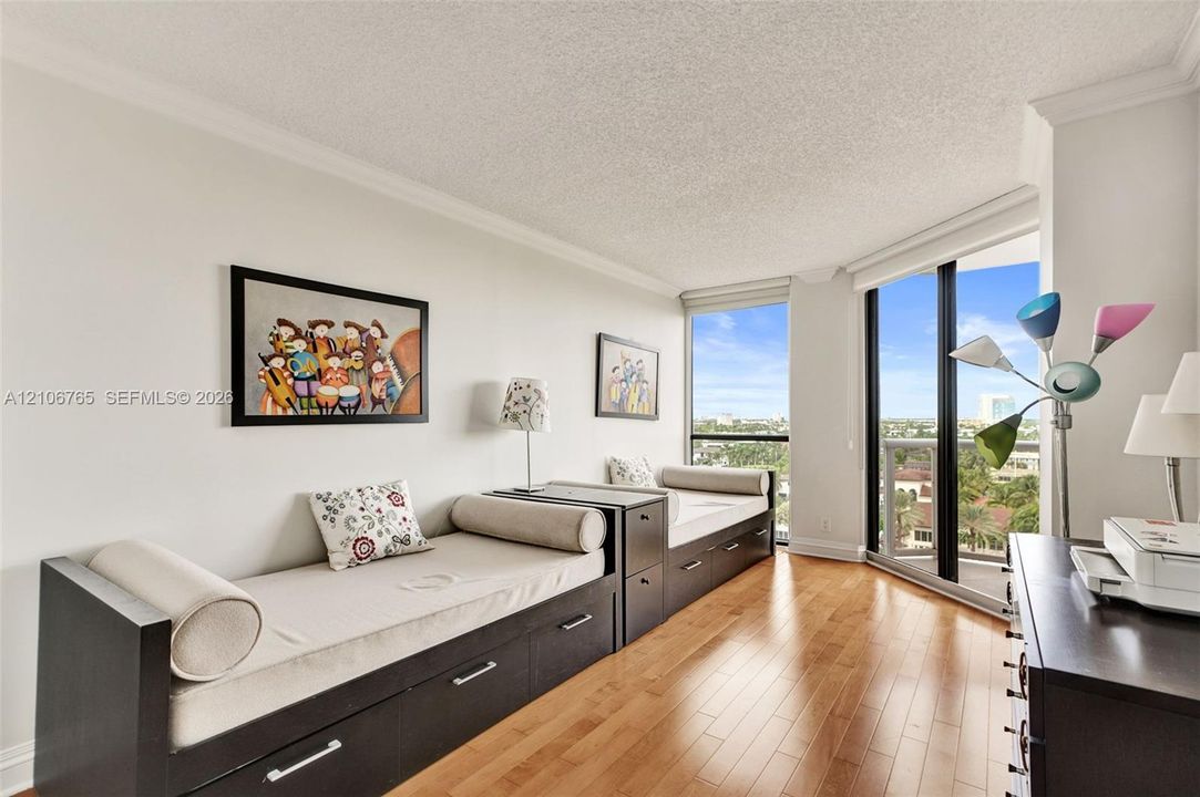 Spacious second bedroom ,floor-to-ceiling windows, wood floors.