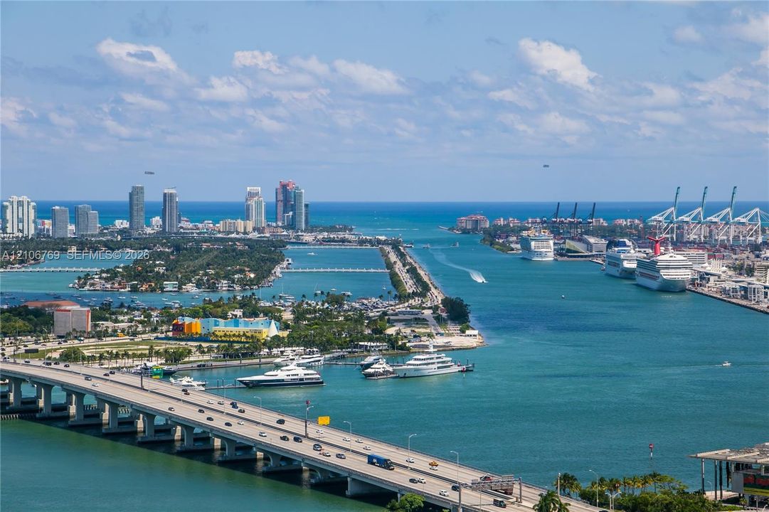 Panoramic coastal horizon featuring the Atlantic Ocean, cruise terminal, island topography, and maritime shipping channels