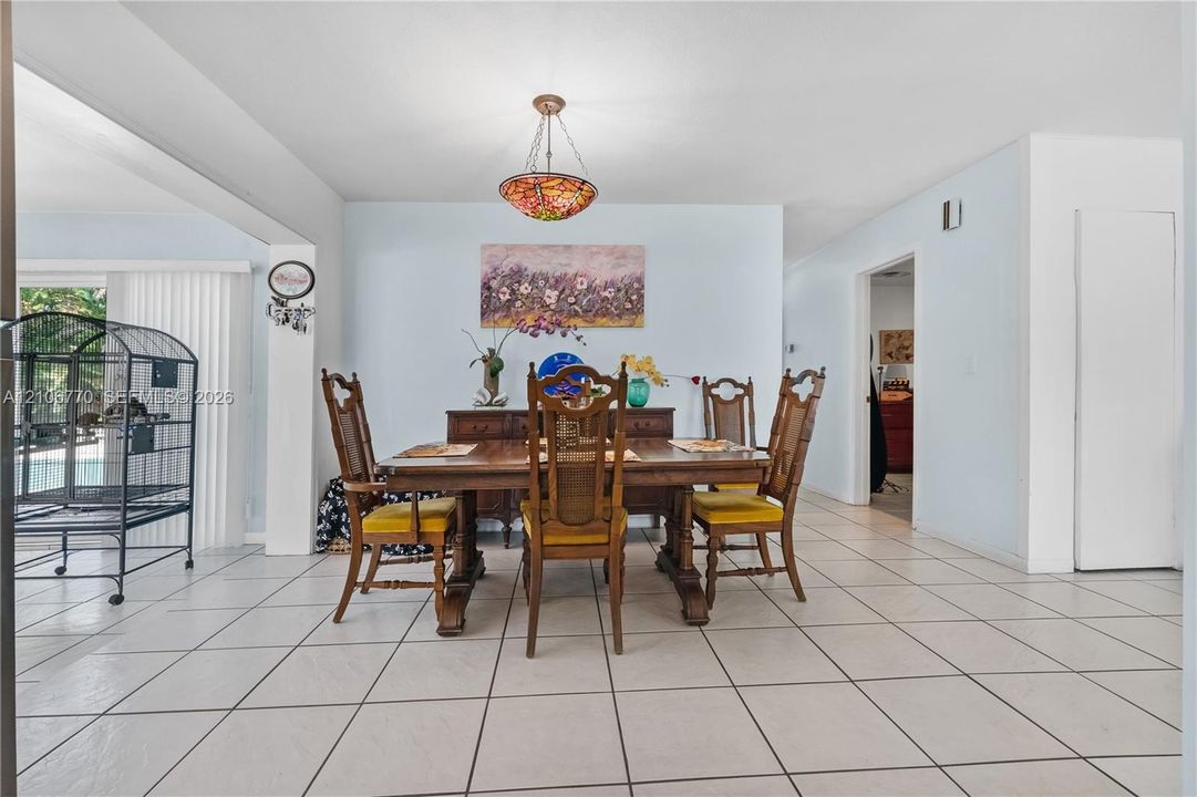 Dining area featuring tile flooring and a decorative stained-glass pendant light fixture