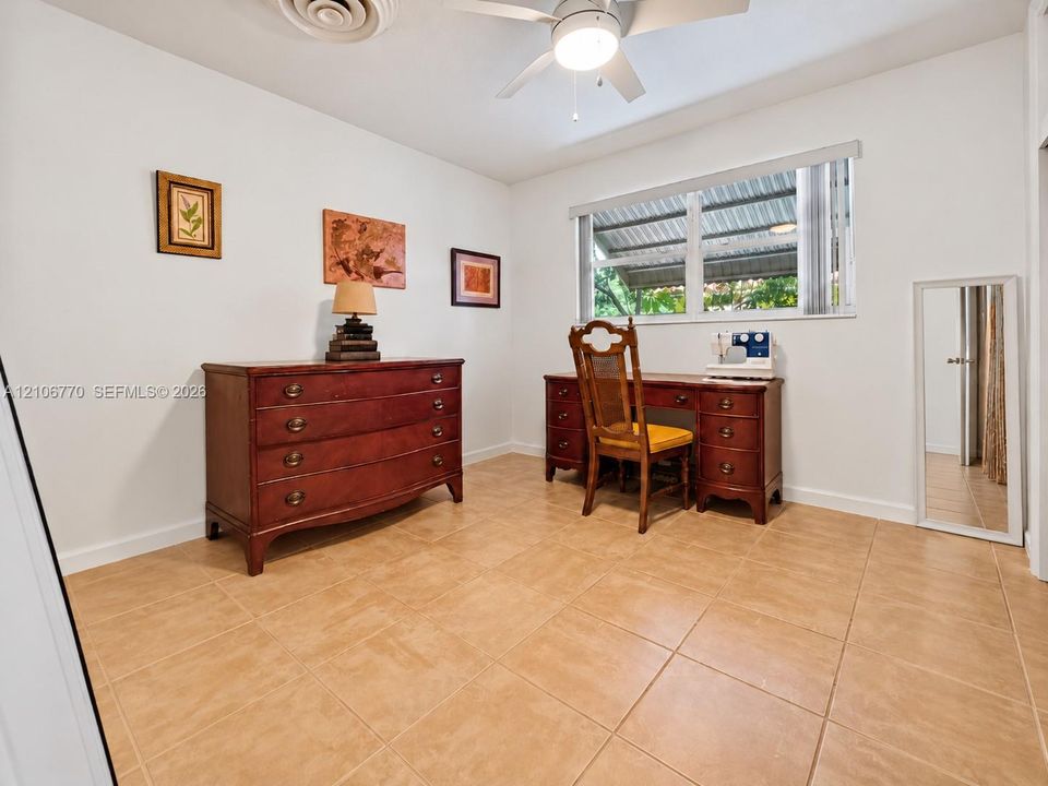 Room featuring neutral walls, large-format tile flooring, a ceiling fan with integrated lighting, and a horizontal window with adjustable blinds