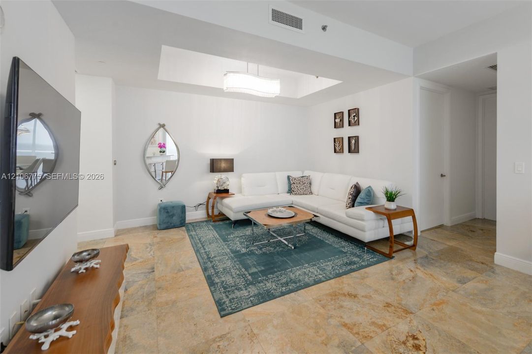 Polished stone flooring, recessed ceiling tray, and integrated light fixture