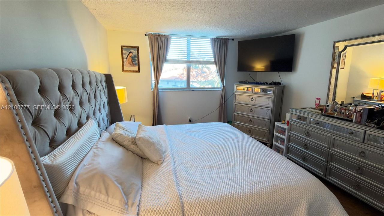 Room featuring a window with horizontal blinds and neutral-toned wall paint