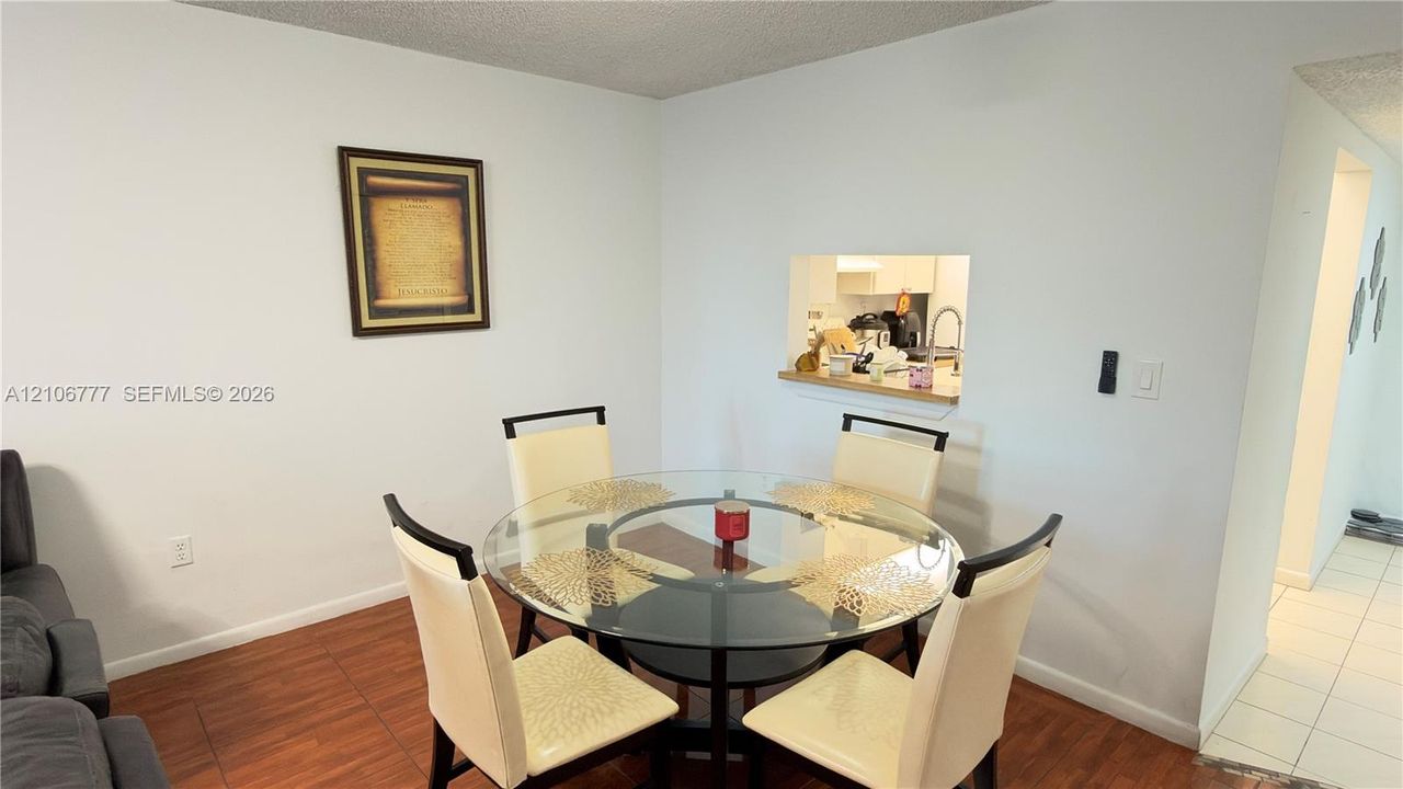 Wood-finish flooring and a kitchen pass-through window with a ledge
