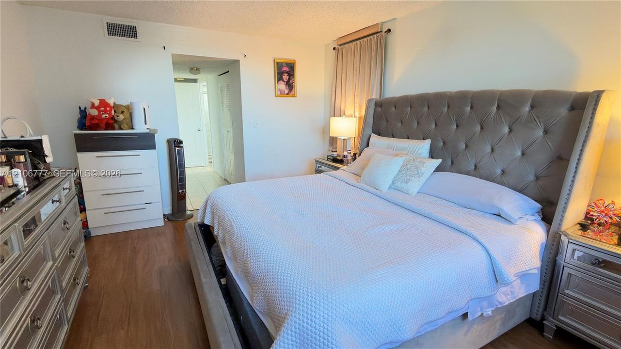 Room featuring wood-finish flooring and neutral-toned wall paint