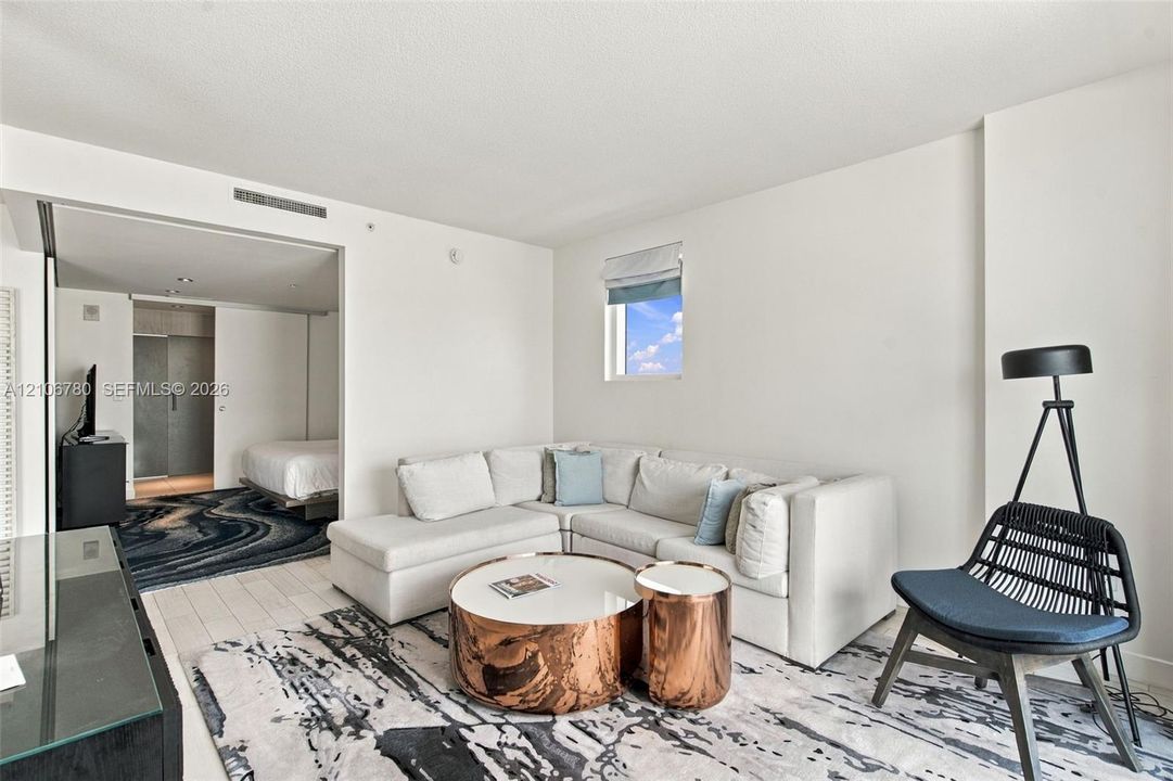 White-toned flooring, recessed ceiling lighting, and expansive interior wall opening
