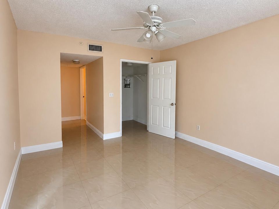 Empty Beige Room with Open Closet and Ce