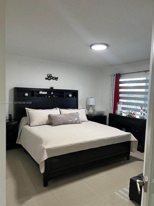 Neutral-toned tile flooring, flush-mount LED ceiling lighting, and dual-layered window blinds