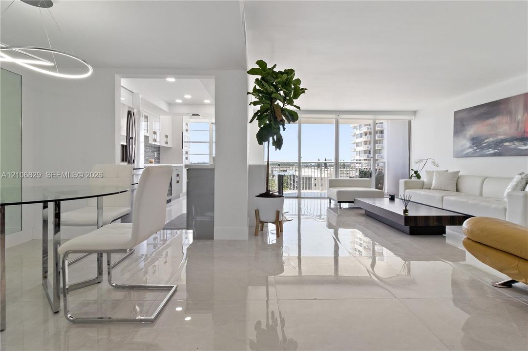 Large-format polished tile flooring, floor-to-ceiling glass wall, recessed lighting, and contemporary circular pendant light fixture