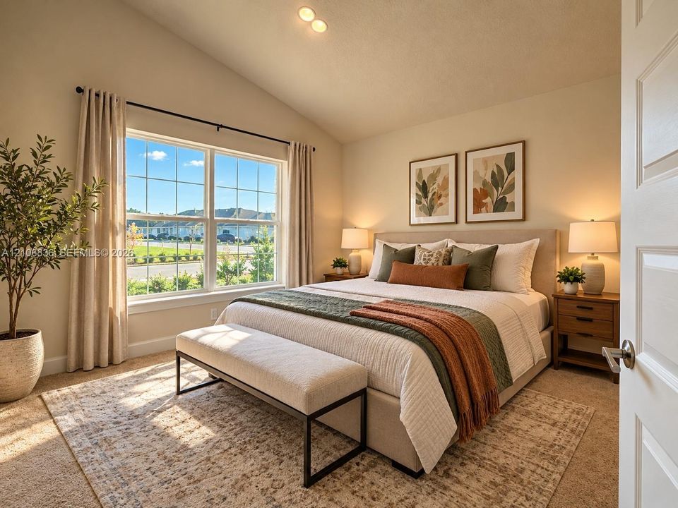 Vaulted ceilings, large multi-pane window, and neutral wall-to-wall carpeting