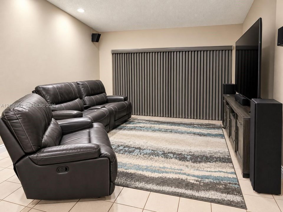 Recessed ceiling lighting, neutral wall finishes, tile flooring, and floor-to-ceiling vertical window blinds
