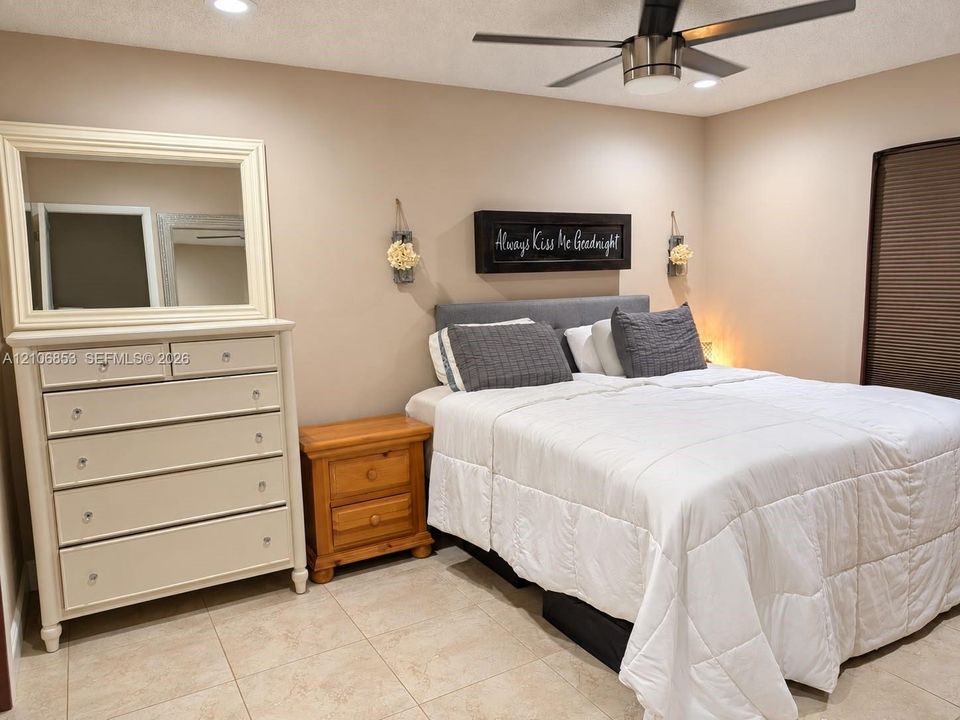 Neutral interior featuring tile flooring, recessed ceiling lighting, and a multi-blade ceiling fan