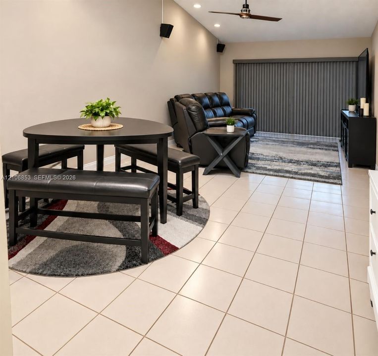 Neutral tile flooring, recessed ceiling lighting, and a ceiling fan with integrated lighting