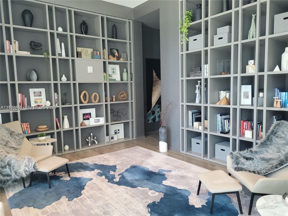 Floor-to-ceiling custom built-in shelving with grey finish and wood-finish flooring