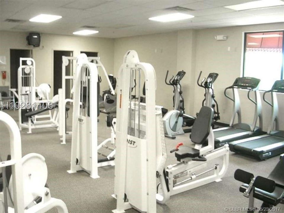 Fitness facility featuring neutral carpeting, recessed ceiling lighting, and multiple large windows