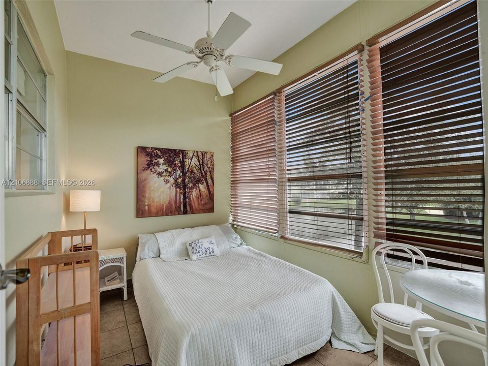Multi-pane window configuration, horizontal window blinds, and white ceiling fan with integrated lighting