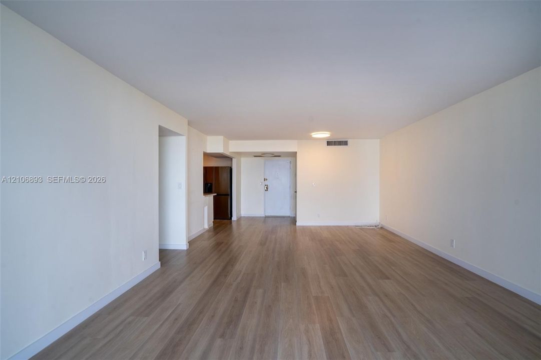 Open interior space featuring light wood-finish flooring and neutral-toned walls
