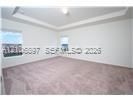 Tray ceiling featuring recessed lighting and wall-to-wall carpeting