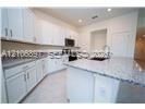 Kitchen featuring white cabinetry, stone-finish countertops, central island, under-mount sink, and recessed lighting