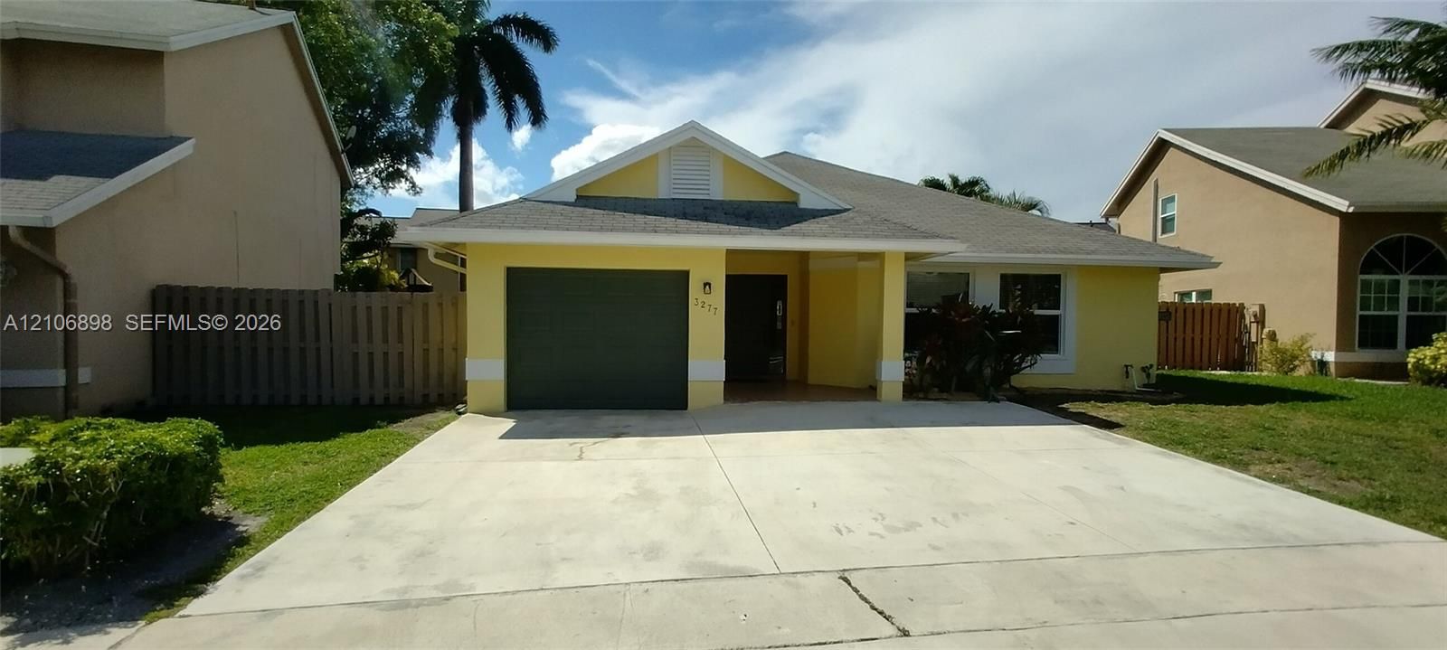Single-story residence featuring a stucco exterior, gabled roofline, integrated single-car garage, and a concrete driveway