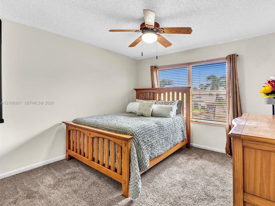Bedroom 4 carpeted flooring, window with horizontal blinds, and ceiling fan with integrated lighting