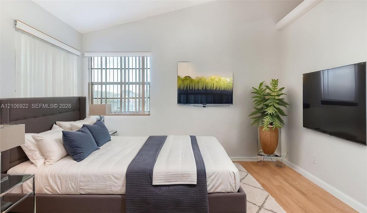 Vaulted ceilings, wood-finish flooring, and natural light from multi-pane windows